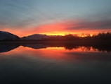 A stunning sunset over a tranquil lake.