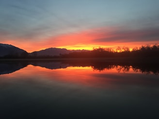A stunning sunset over a tranquil lake.