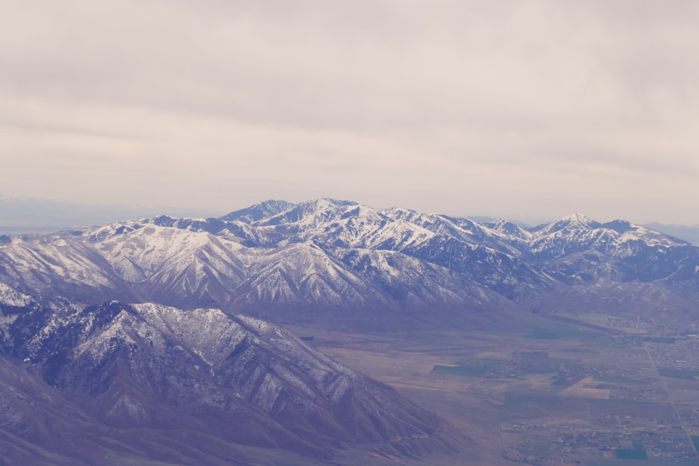 a view of snow covered mountains from an airplane