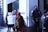A group of people is standing outside a building, with two police officers observing them. One person is holding a protest sign which reads 'CROWN HEIGHTS TENANT UNITE & FIGHT'. The weather appears cold and some individuals are wearing hats and coats.