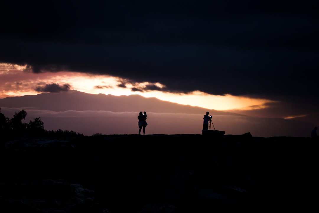 silhouette photo of woman carrying baby