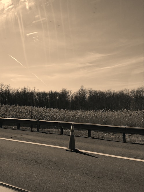 A calm, minimalistic illustration of a construction cone and tools indicating maintenance work.