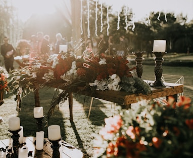 assorted-color flower decors on table with candle holders