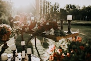 assorted-color flower decors on table with candle holders