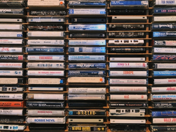 Stacks of audio cassettes waiting to be digitized in a cozy studio.