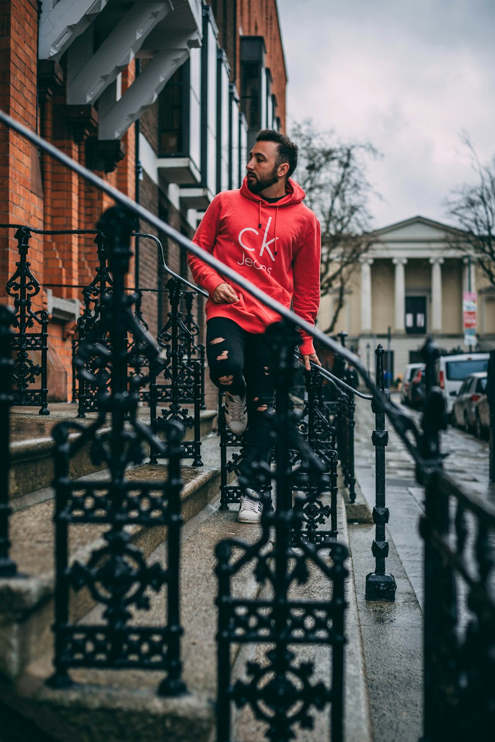 man standing on gray stair near building taken at daytime