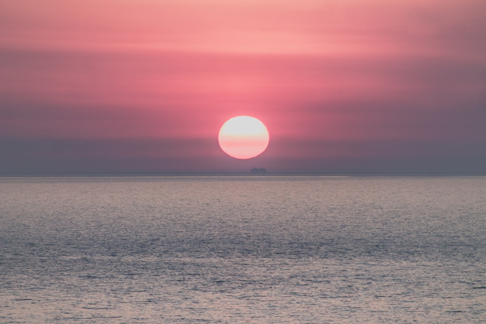 sun setting on ocean horizon
