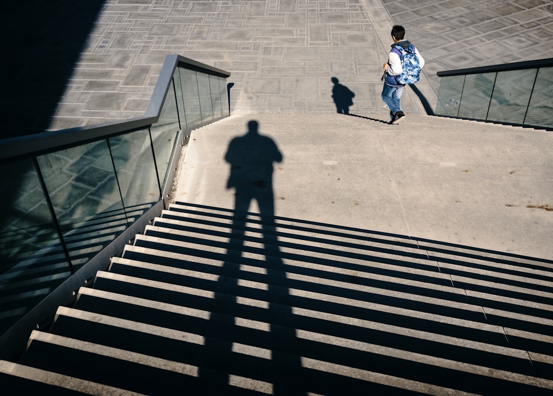 man walking on stairs during daytime