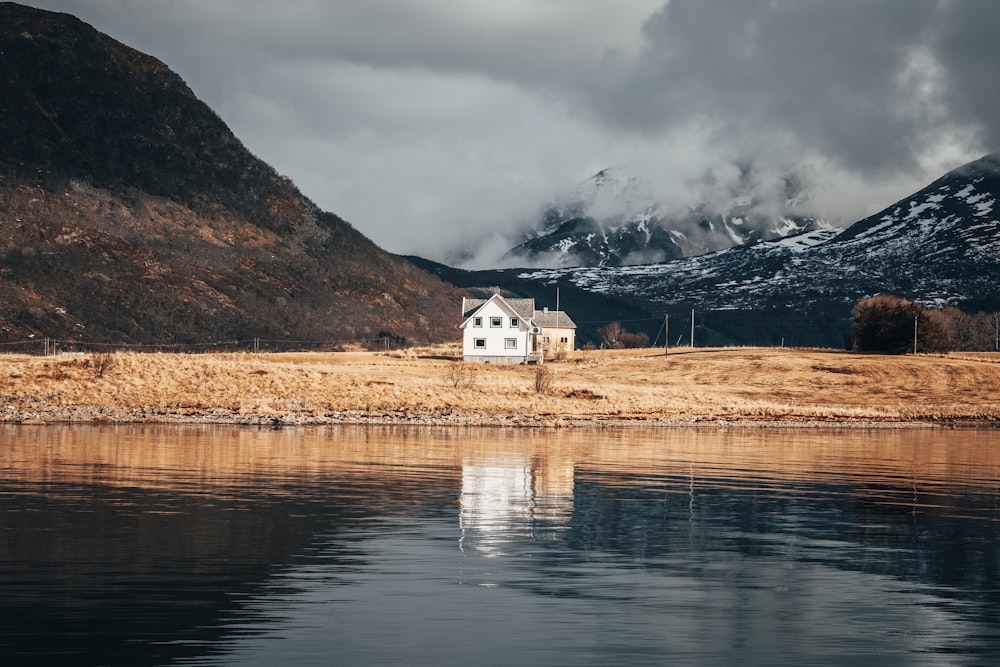 white house near body of water