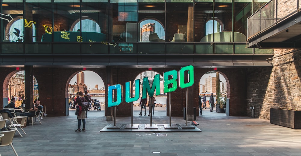 people walking near Dumbo signage