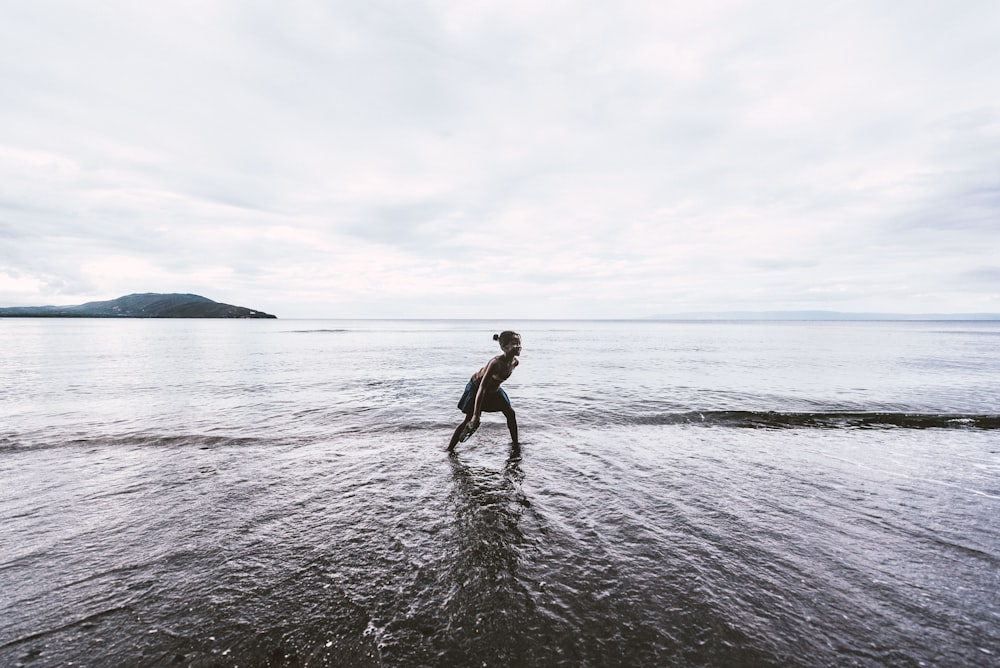 person on body of water standing