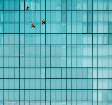 three men cleaning windows