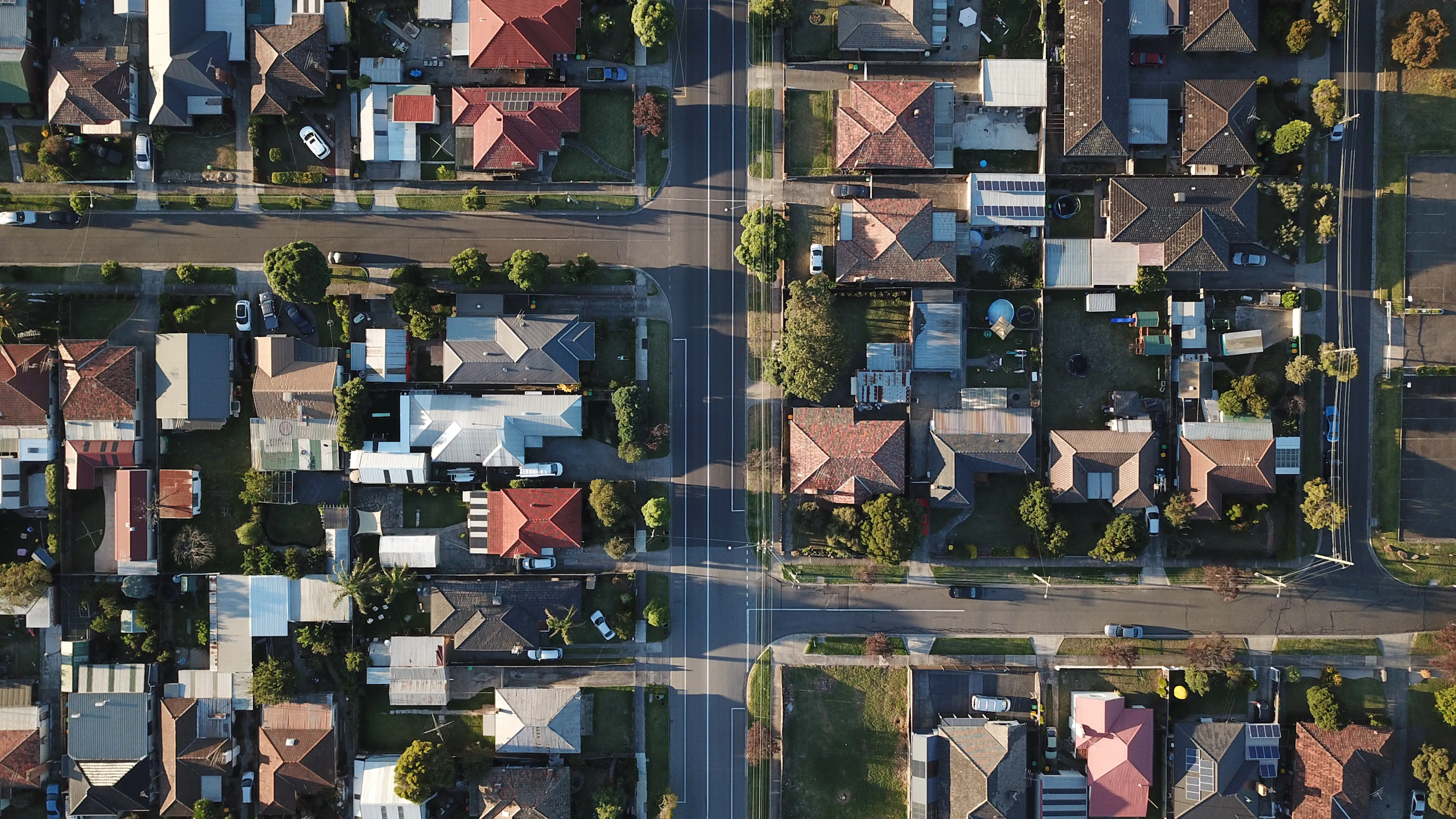 Aerial view of an Australian suburb — streets, rooftops and gum trees