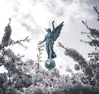 angel green concrete statue low-angle photo