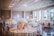 An elegantly decorated banquet hall featuring floral arrangements and ambient lighting, creating a warm and inviting atmosphere.