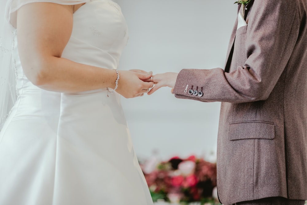 woman holding hands with man in front of altar