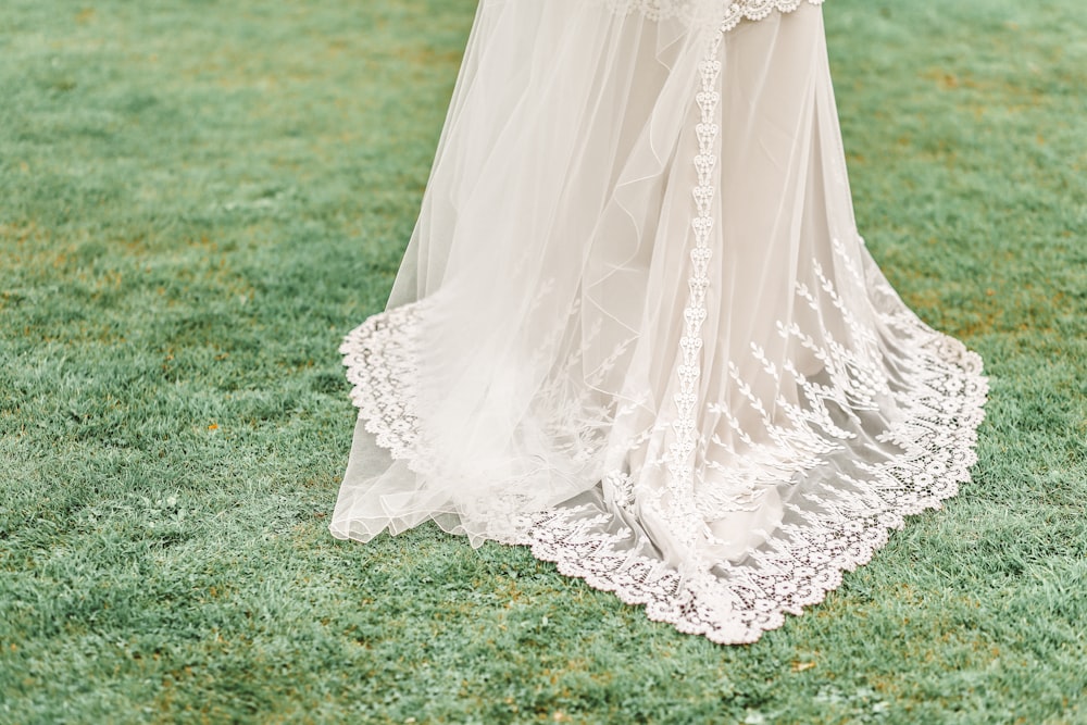 woman wearing white gown on grass