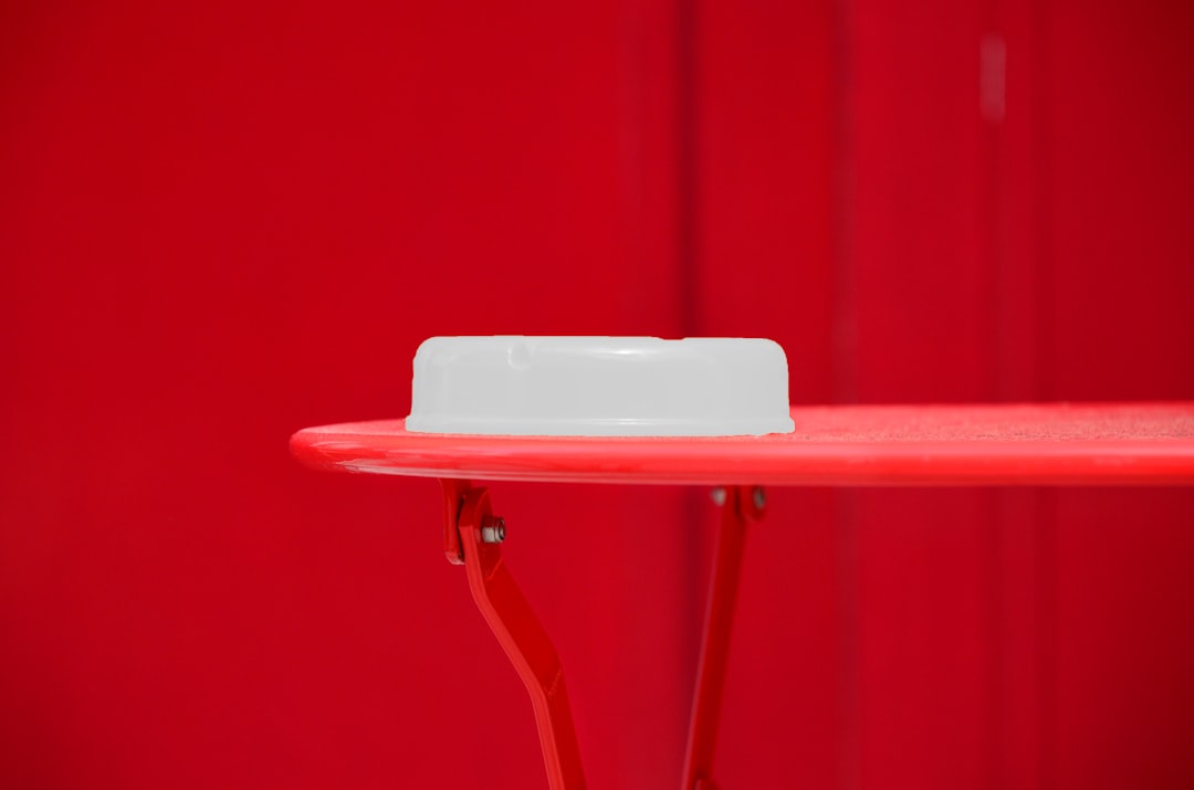 round white plastic container on red table