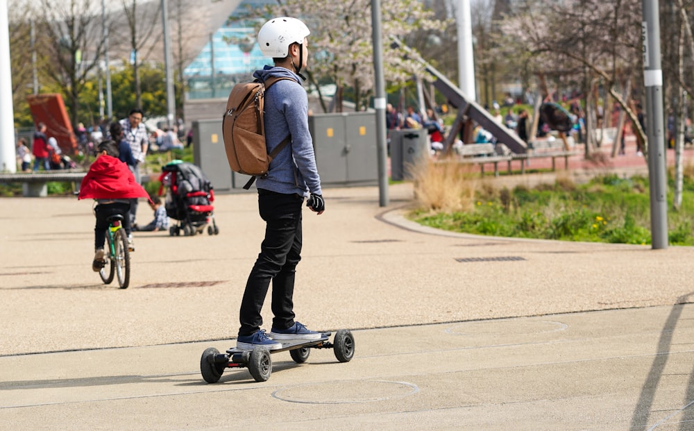 man riding skate on road during daytime