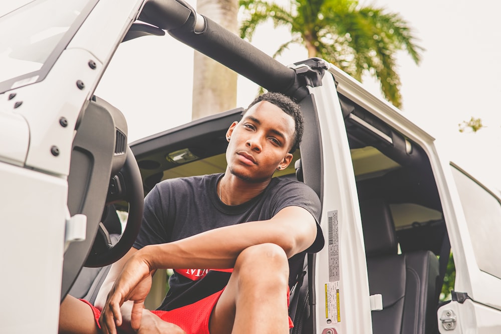 man sitting on vehicle