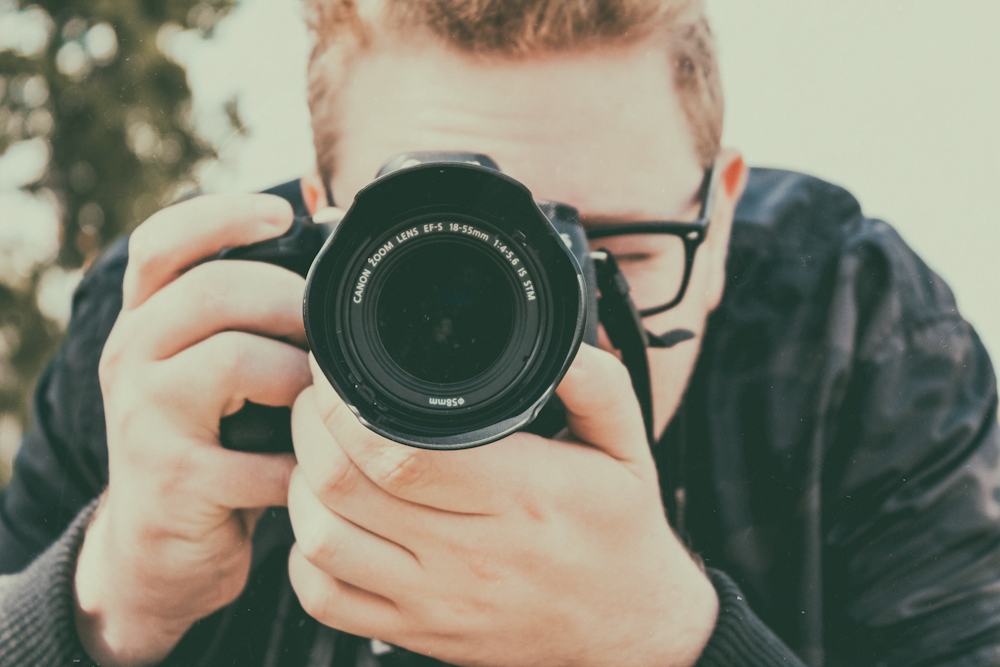 man taking photo using camera