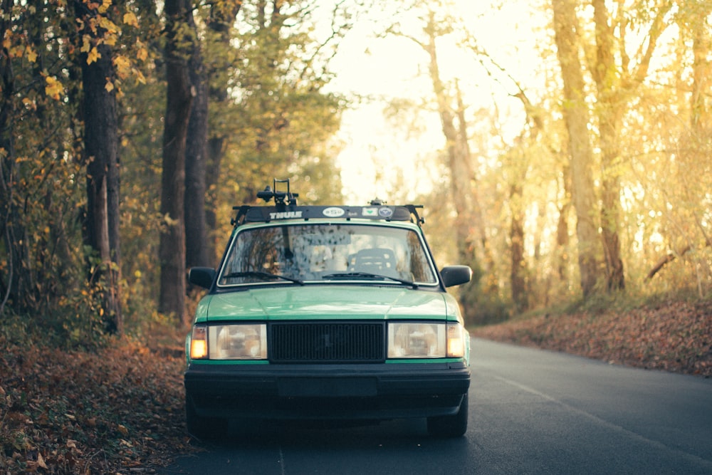 green car surrounded by trees