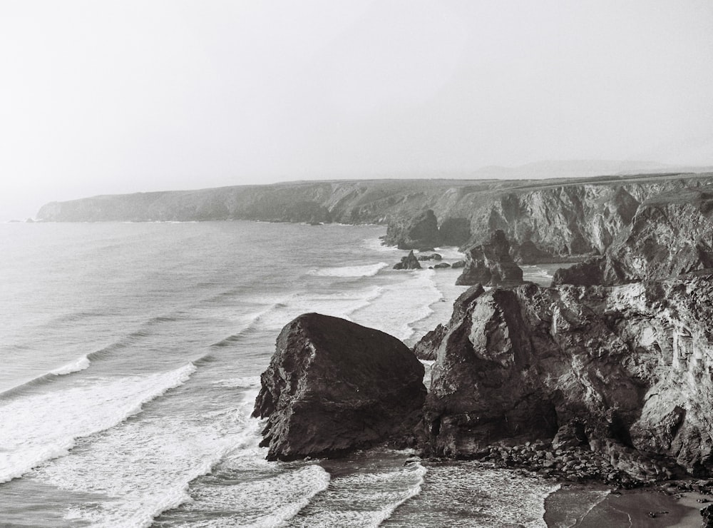 aerial photography of waves crashing on coastal rocks at daytime