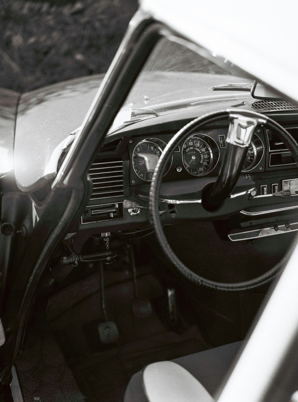 grayscale photo of a vehicle steering wheel