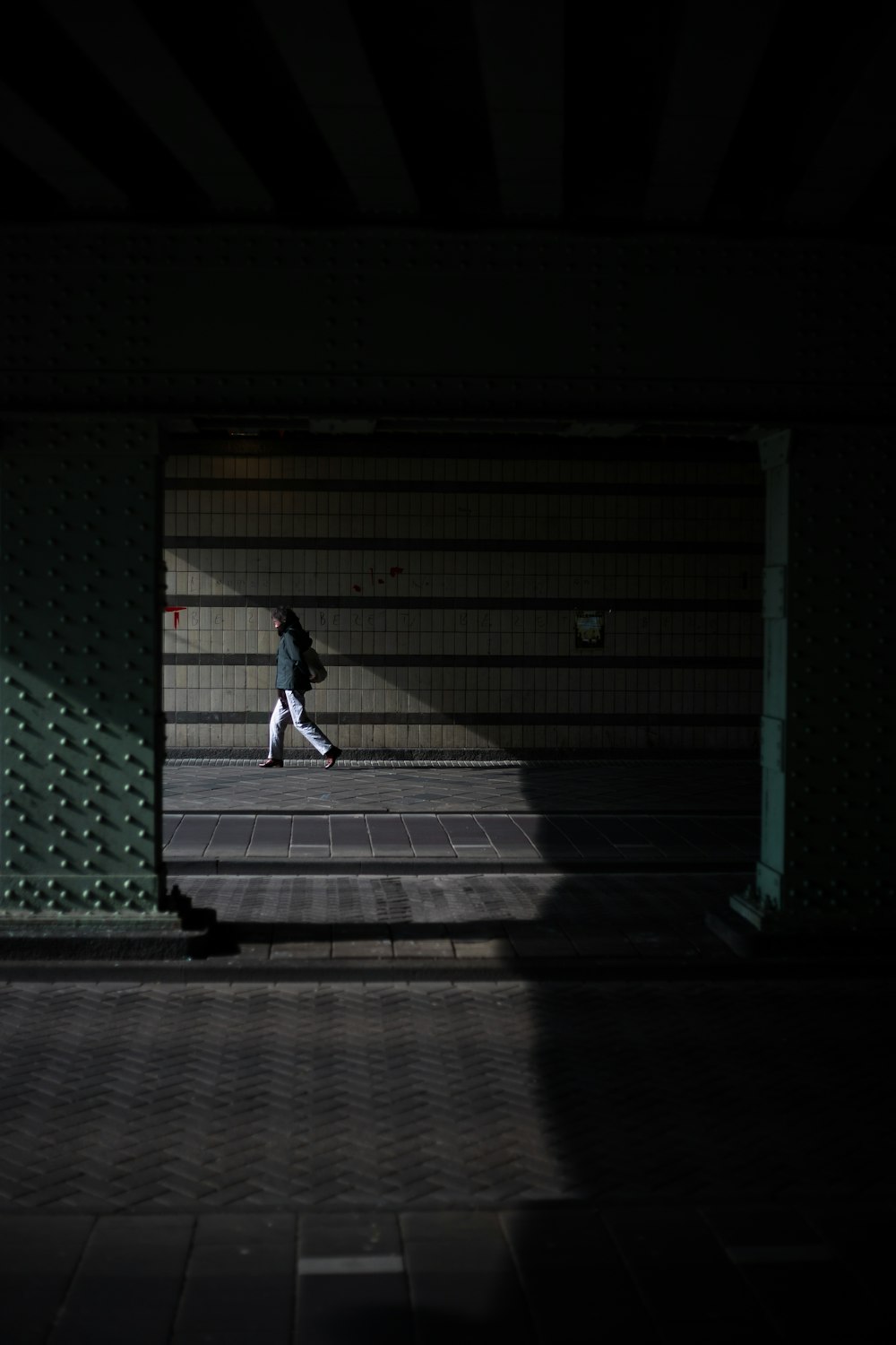 man walking near wall