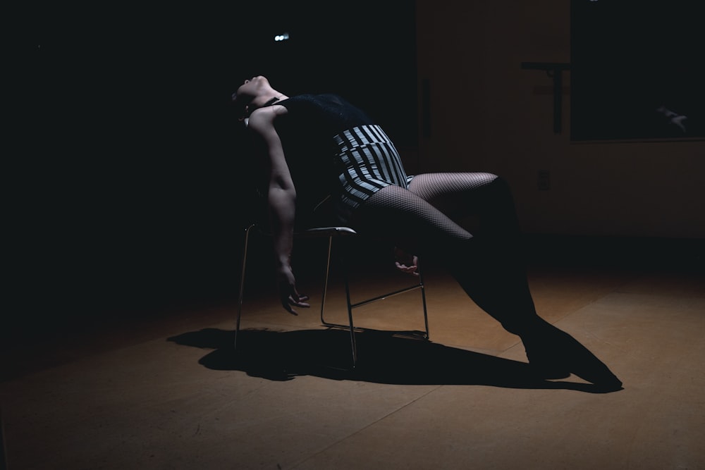 woman sitting on chair near wall