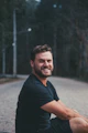 man sits on road