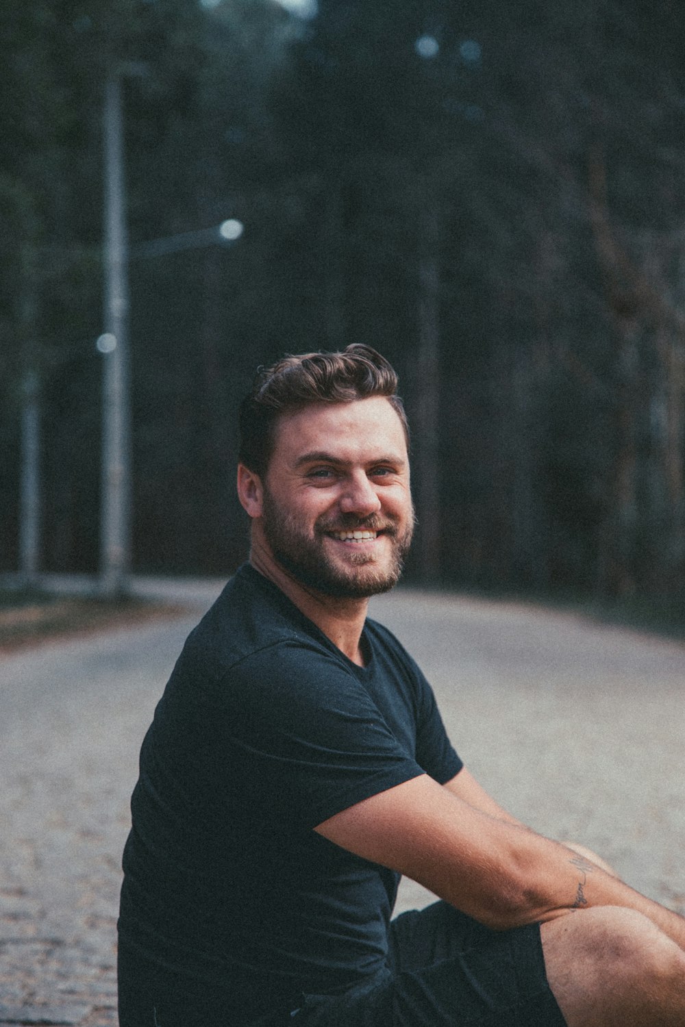 man sits on road