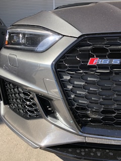 Close-up of the Audi A4's LED headlights and grille, highlighting its sharp design.