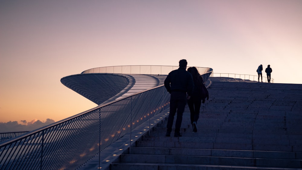 four people climbing stairs during daytime