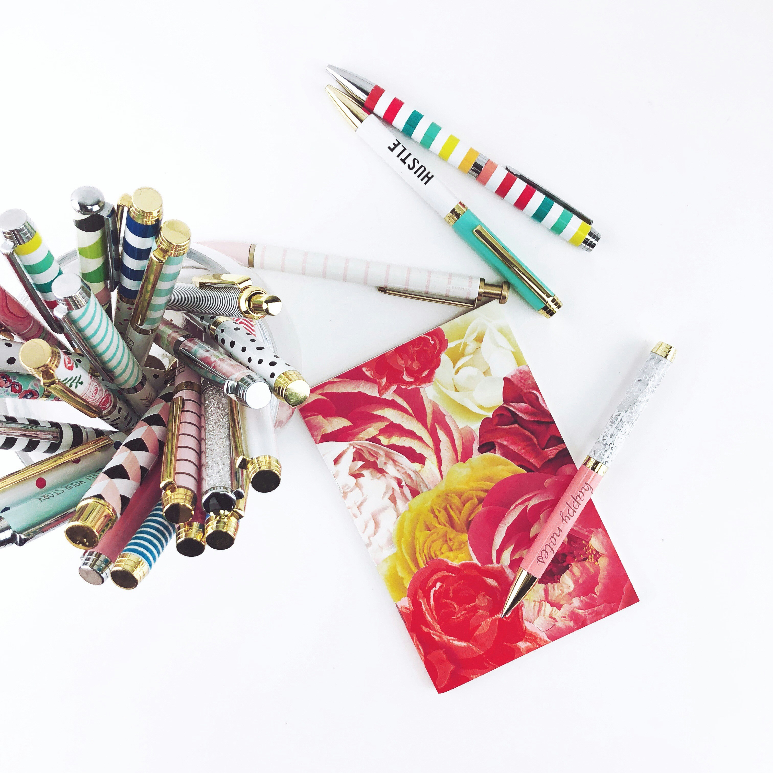 assorted-color retractable pen on white background