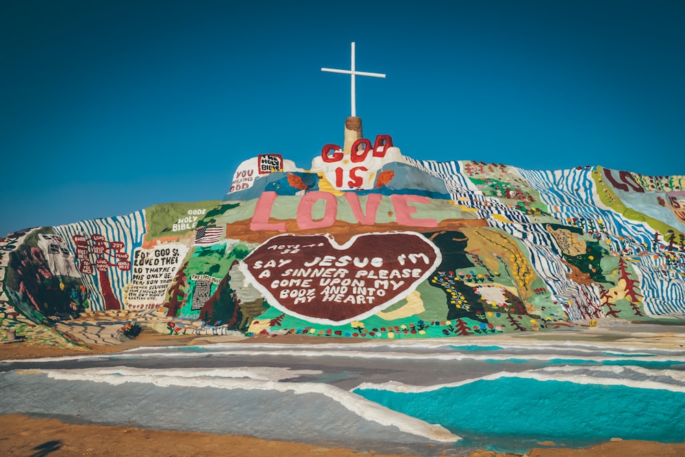 god is love Jesus wall painting during daytime