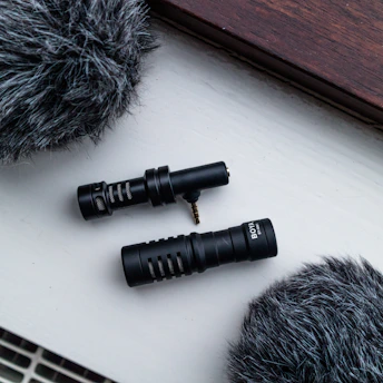 A sleek black and white microphone set against a minimalist background, symbolizing insightful business podcasts.