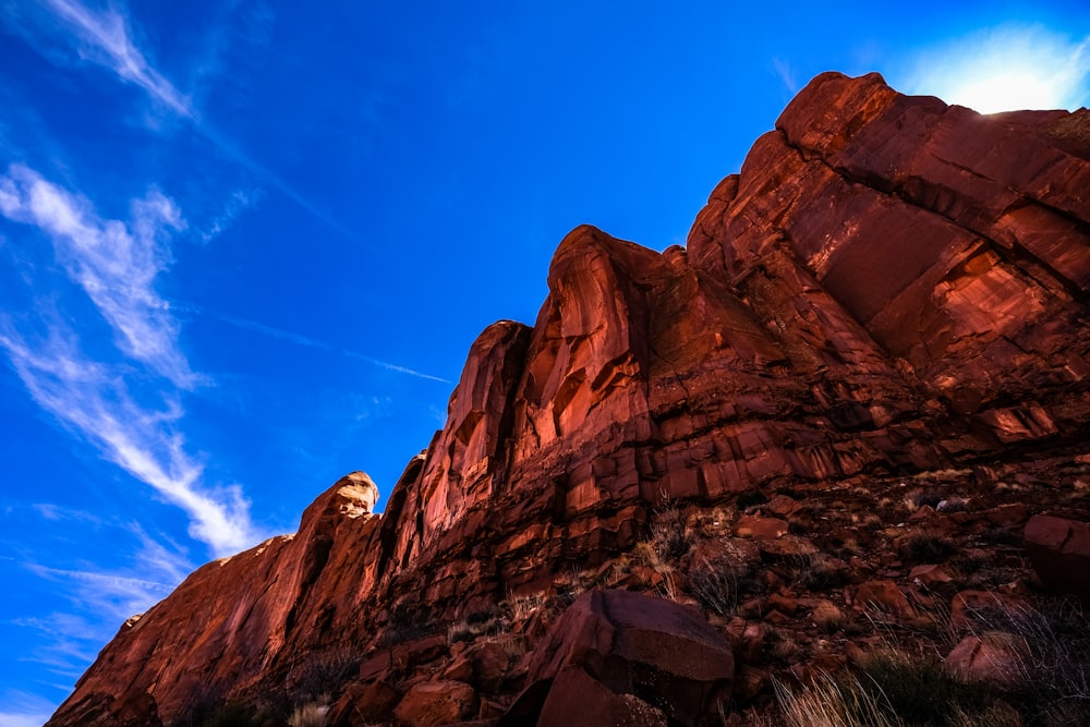 brown rock formation under blue skies