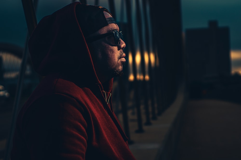 man standing near cable bridge