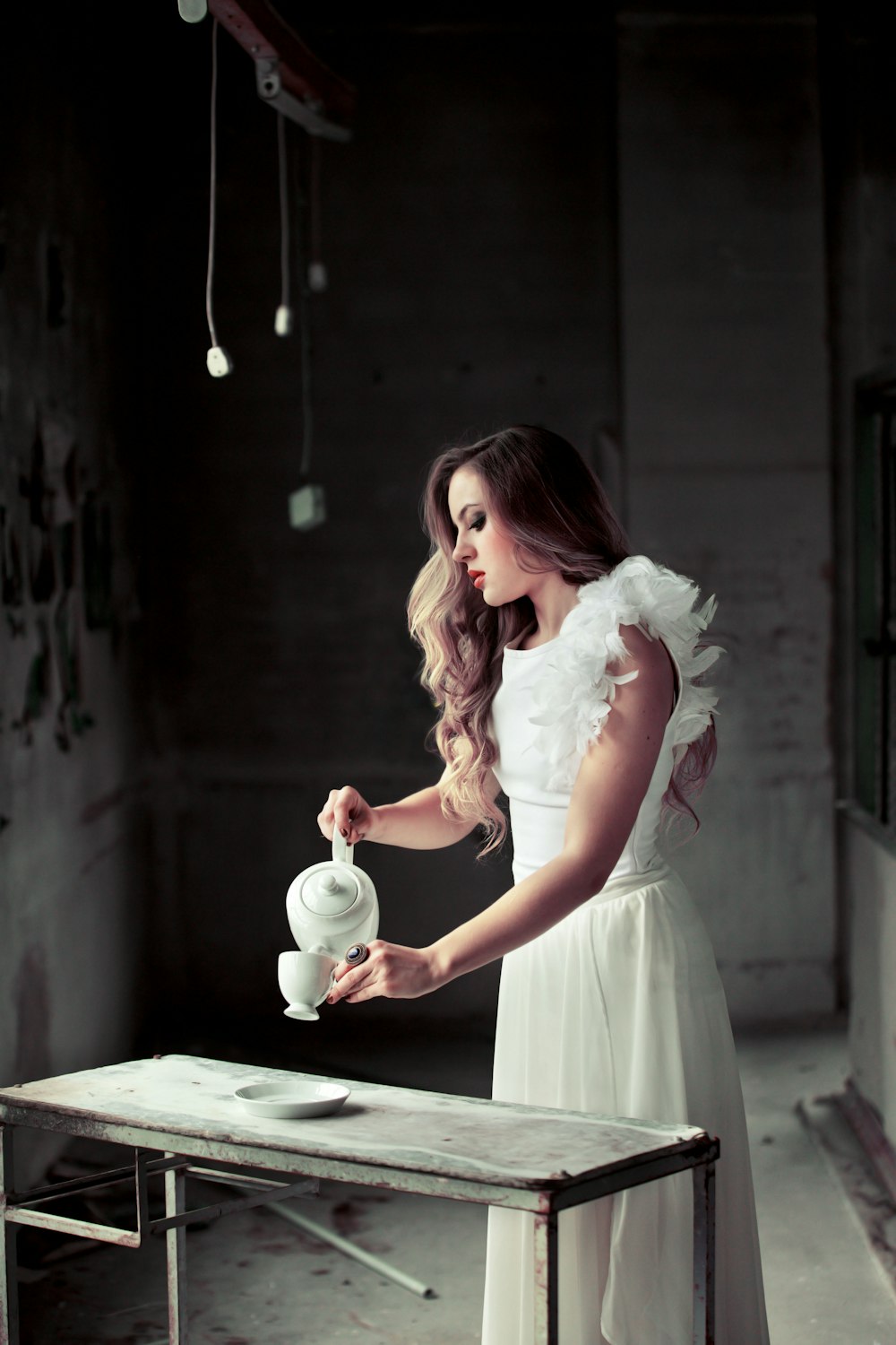 woman pouring tea in cup