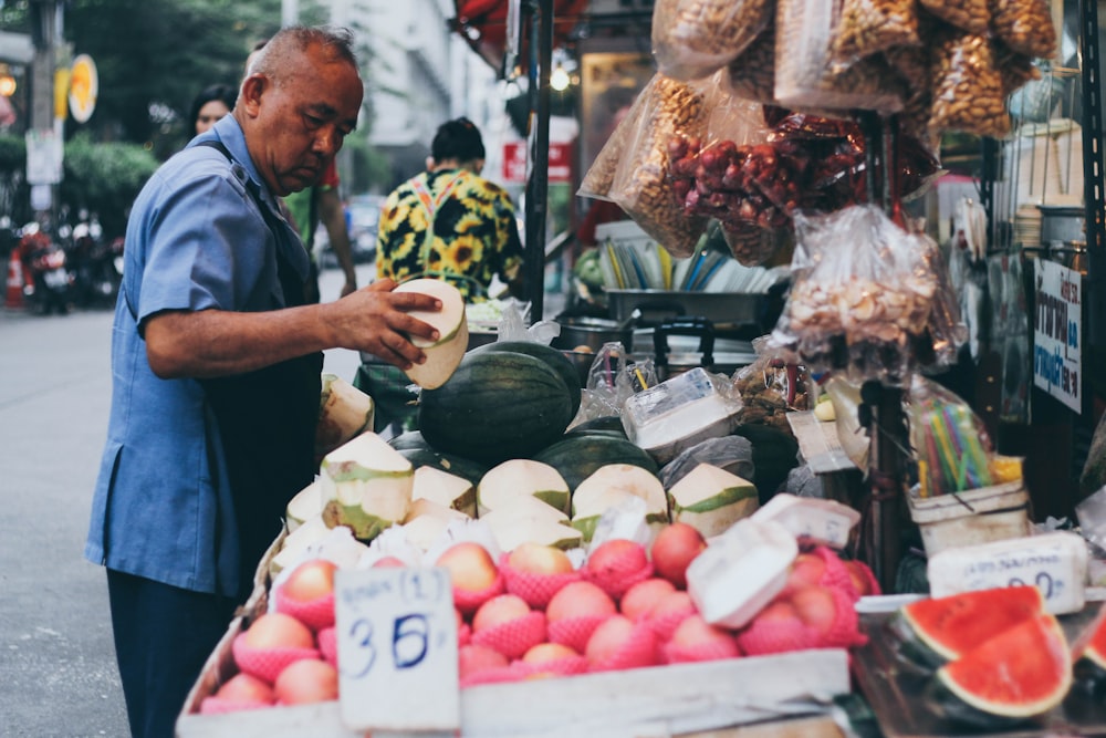 man buying fruits on store