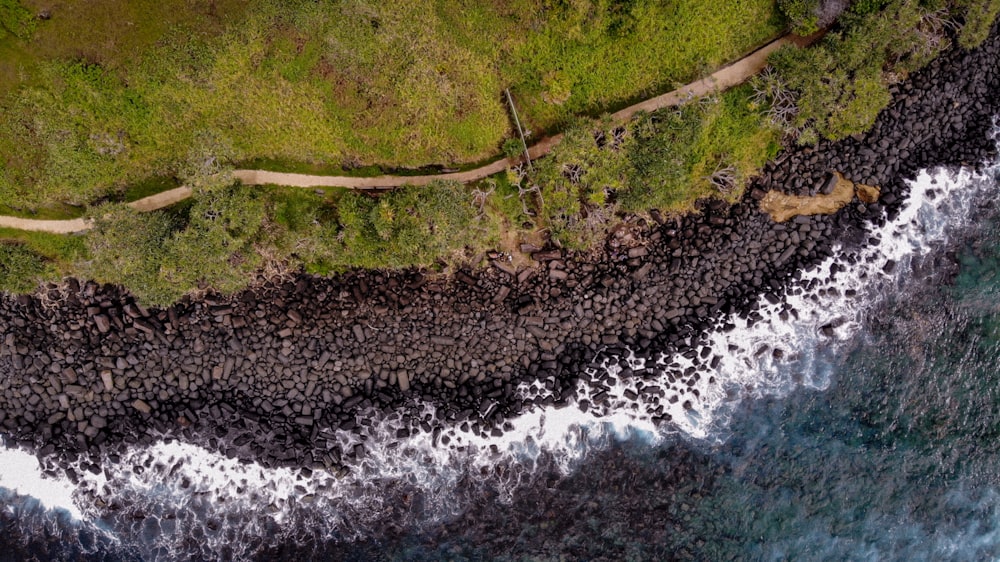 aerial photography of shoreline with rocks