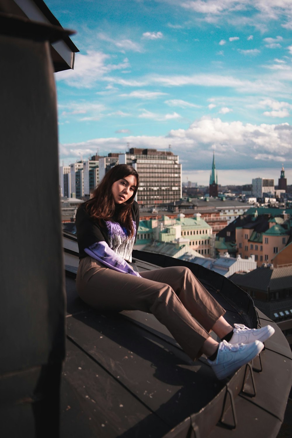 woman sitting near buildings