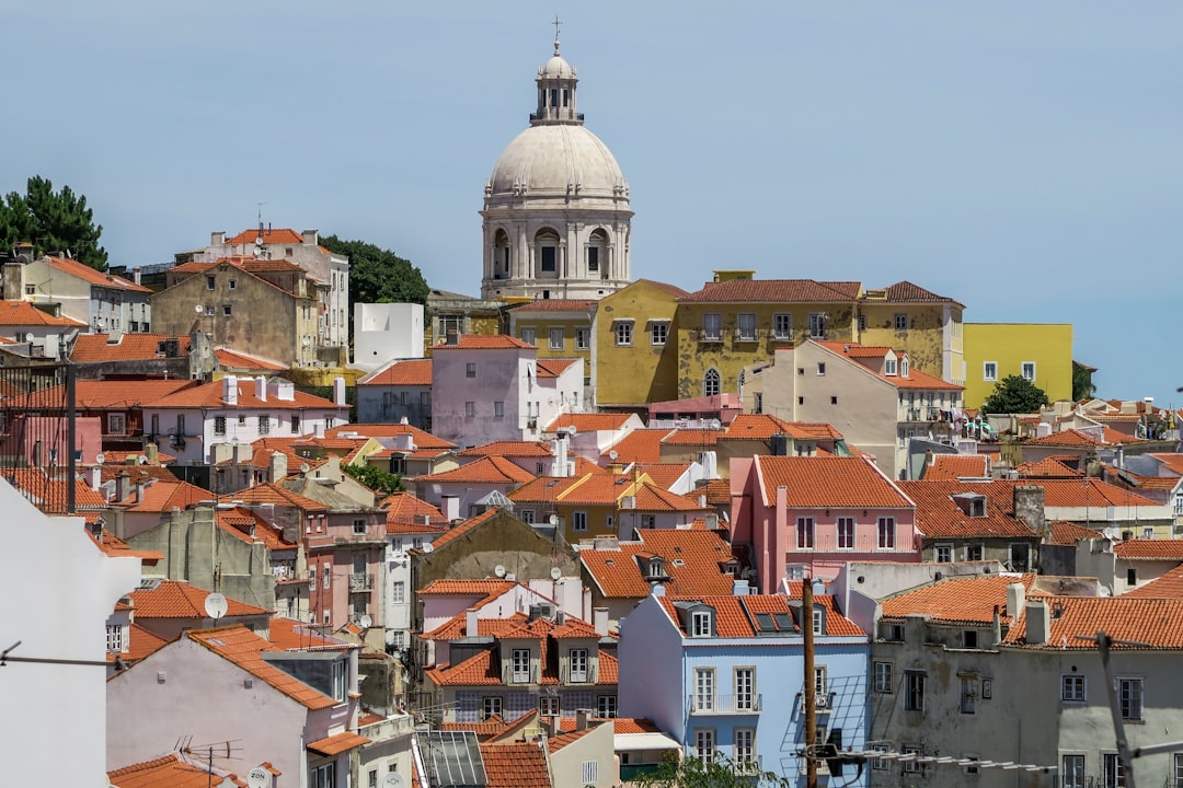 aerial photography of town with red roof houses near dome gothic cathedral, City skyline of Lisbon in Portogal
