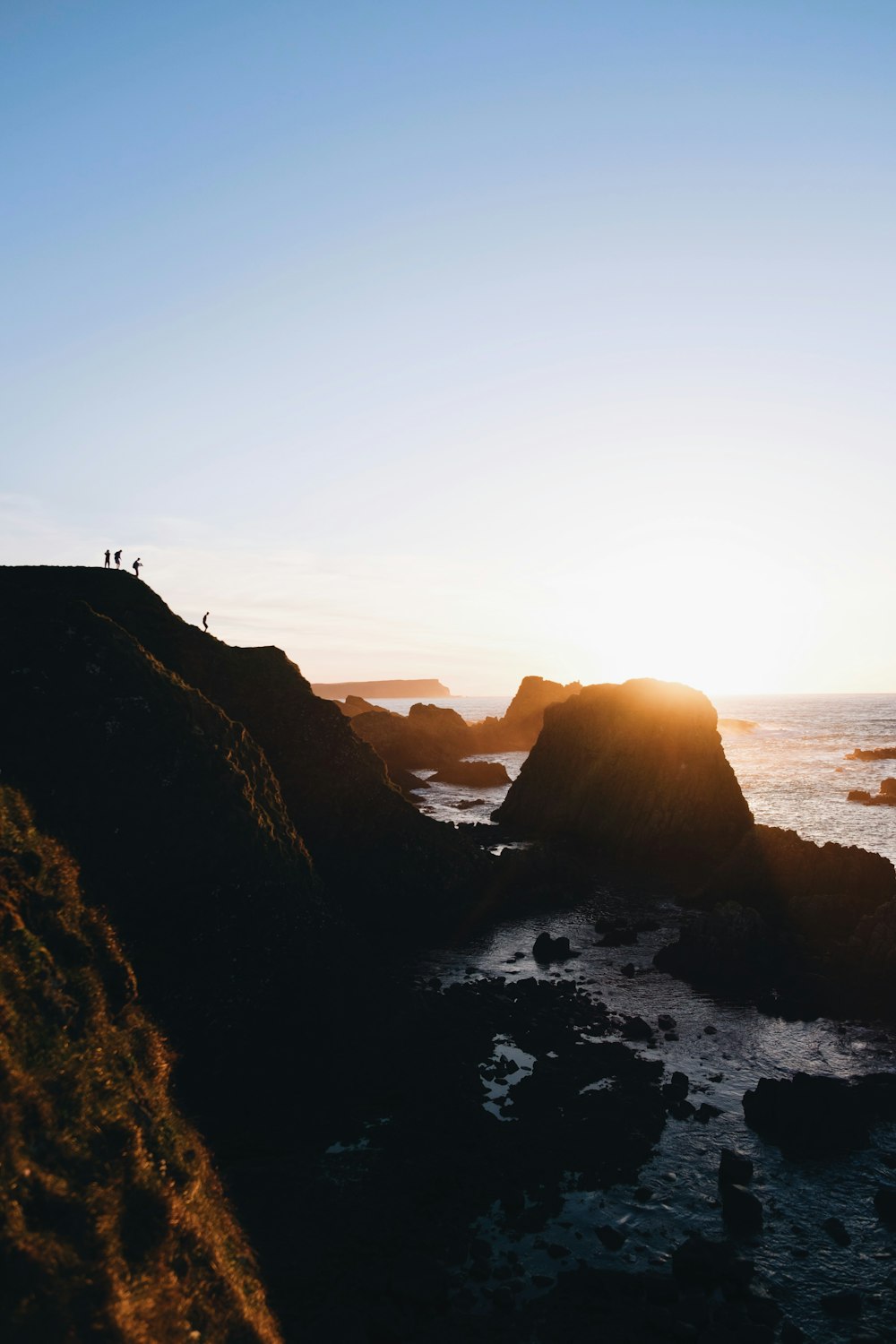 group of person standing on cliff