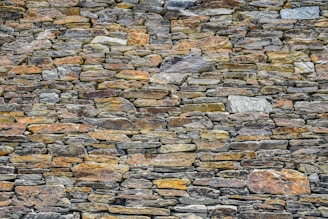 A beautifully crafted dry stone wall showcasing expert masonry.
