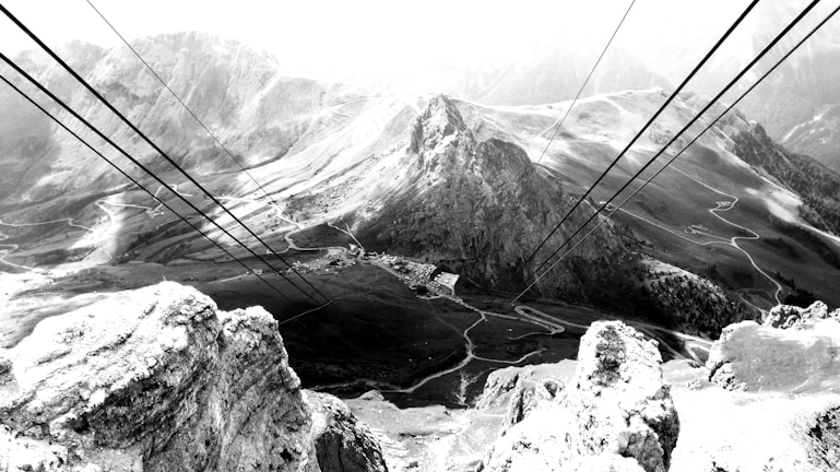 Close-up aerial photo of telecom cables stretched over challenging terrain.