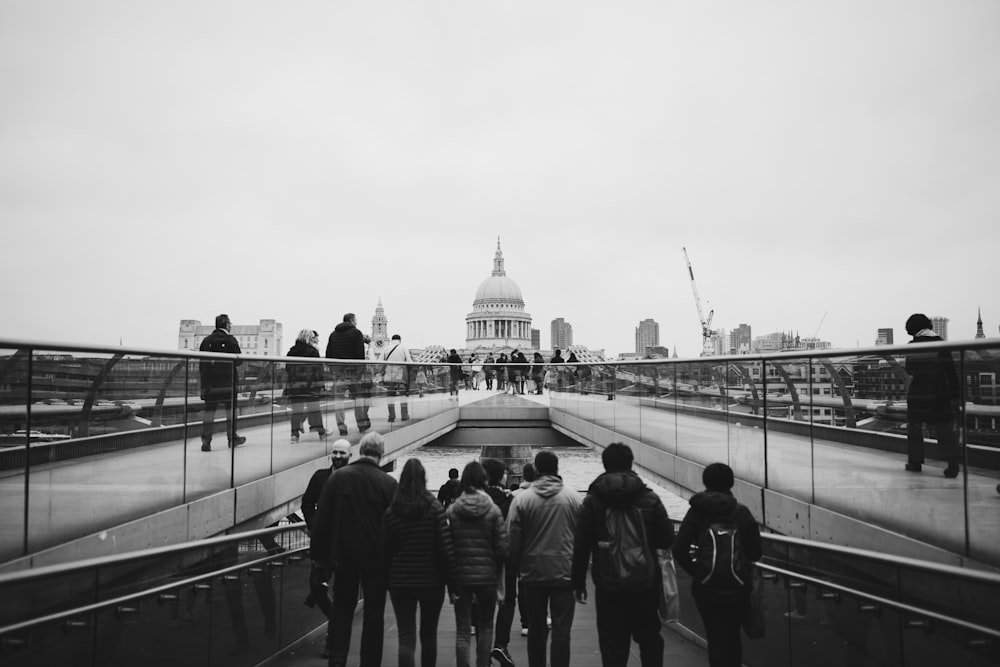 grayscale photo standing near church