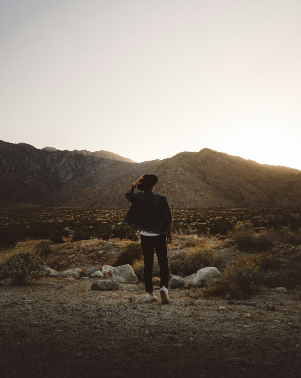 person walking on brown field