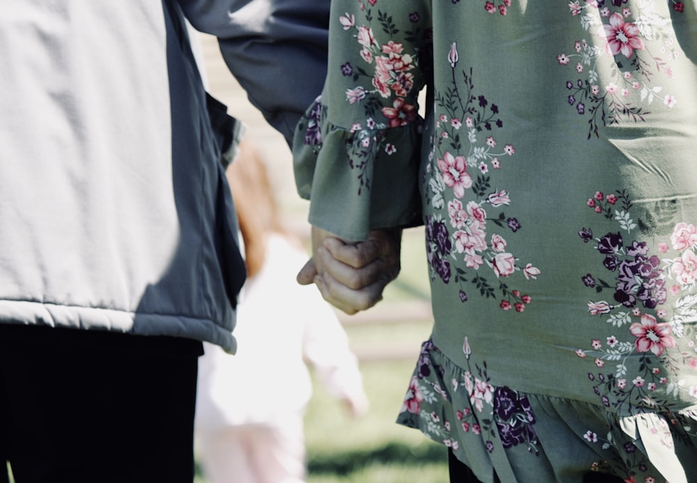 person wearing green and pink floral jacket